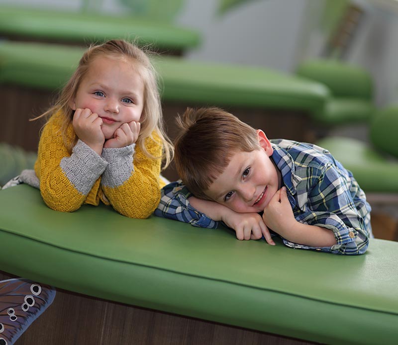 children laying on dentist chair